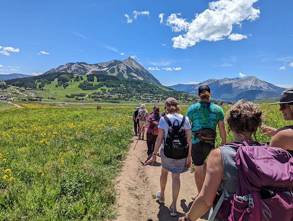 Hikers on a trail heading to a mountain