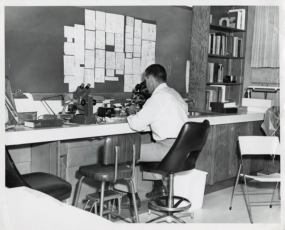 Old photo of man at lab table
