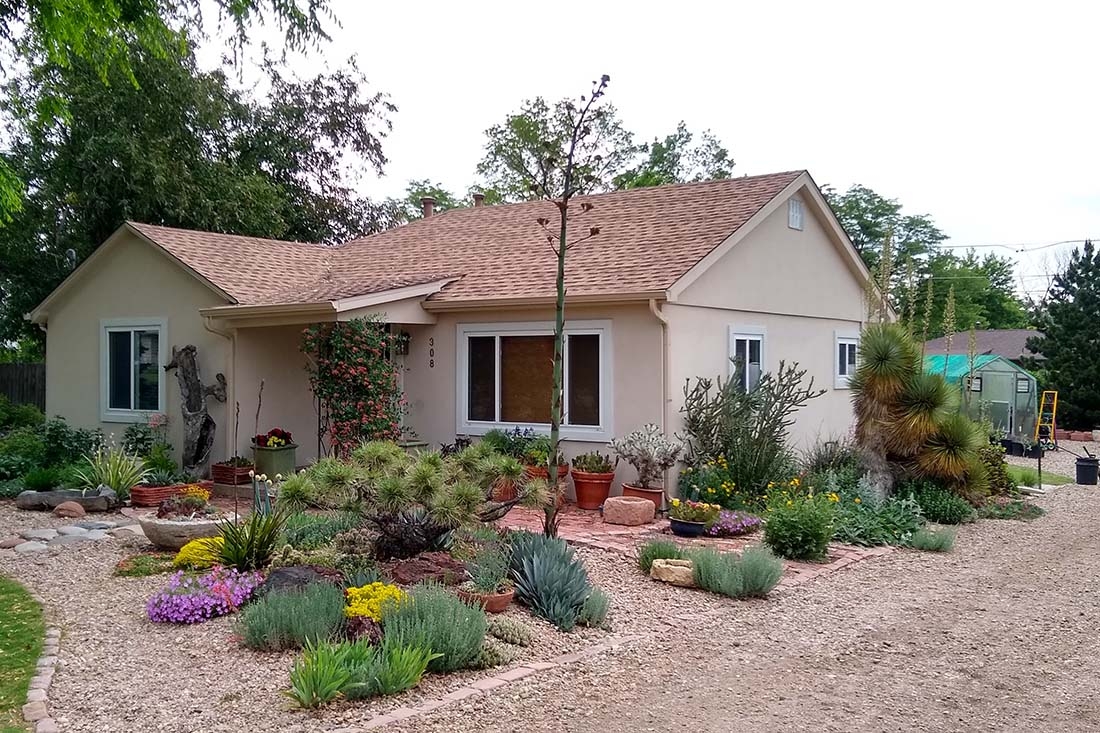A colorful xeric garden in front of a house