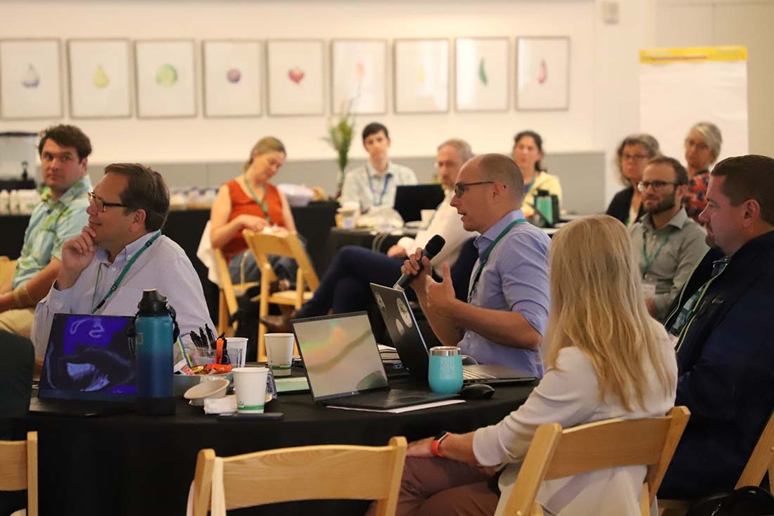 Close up of people at a table during discussion at convention