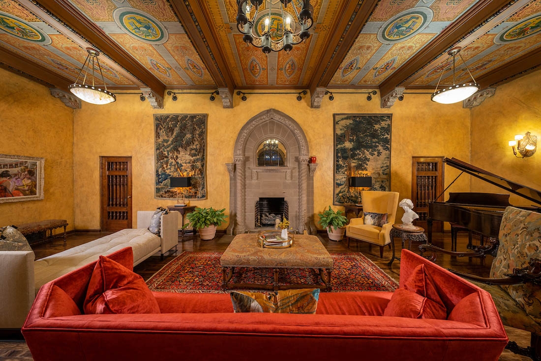 A historical mansion with fireplace and couches