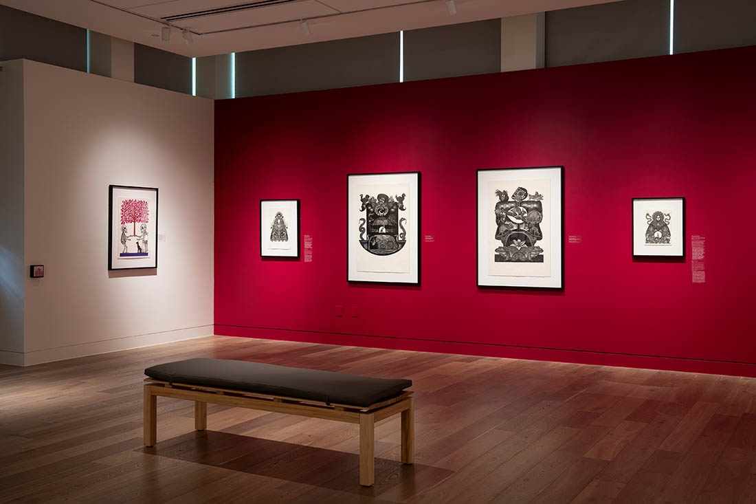 art gallery with red accent wall and black and white images