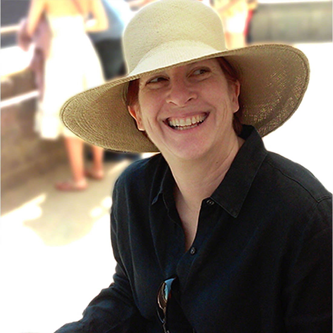 Woman in straw sunhat and black shirt