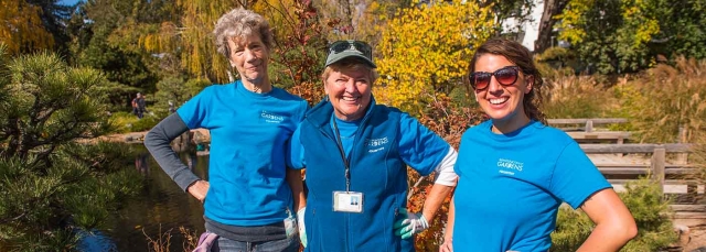 Three volunteers outside in the Japanese Garden