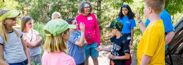 Instructor talking to children outside