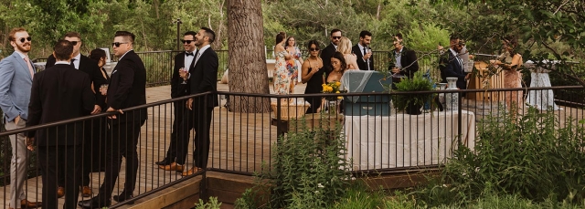 People outside on a deck talking during cocktail hour