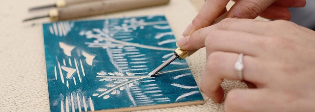 Person creating a woodcut